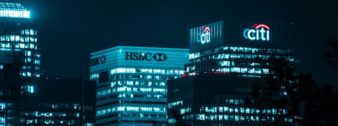 skyscrapers with bank logos at the top in a skyline image