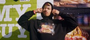a man pulling the hood of his sweater over his head