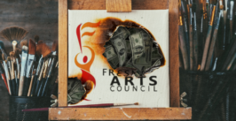 a smoldering painting with money behind the hole