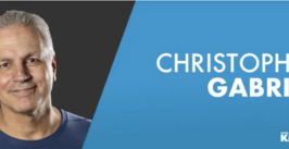 man smiling next to text of his name