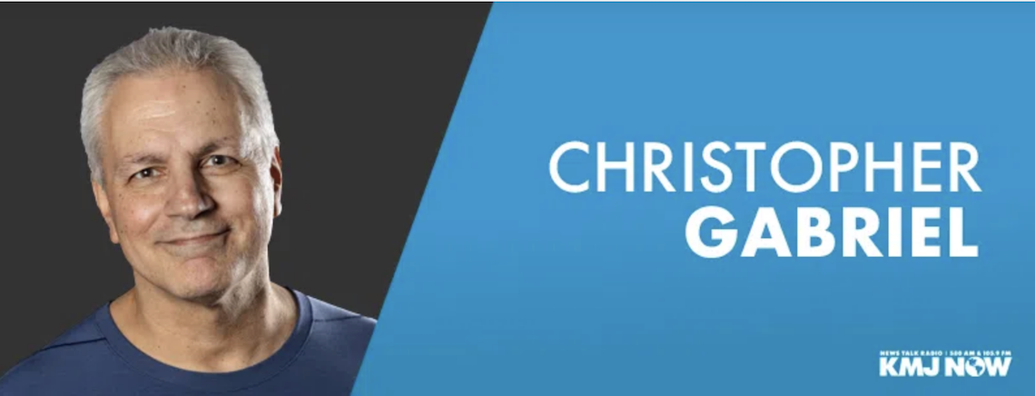 man smiling next to text of his name