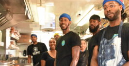 people posing for a photo inside a food truck