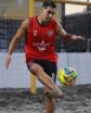 beach soccer player dribbling ball