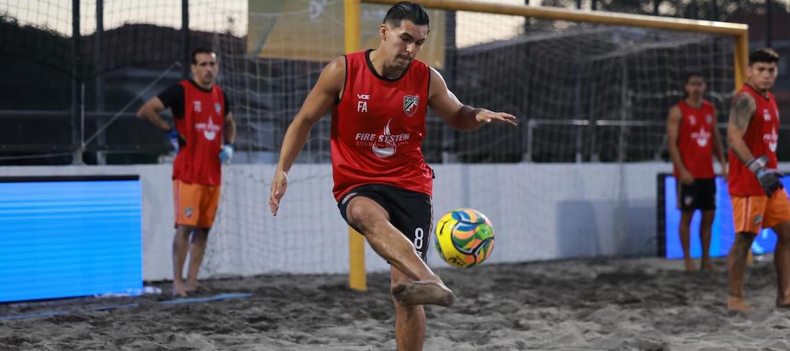 beach soccer player dribbling ball