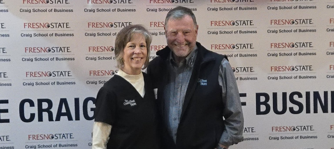 two people in front of a backdrop