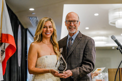 man and woman with award