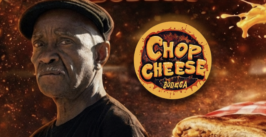 man next to a chop cheese bodega logo