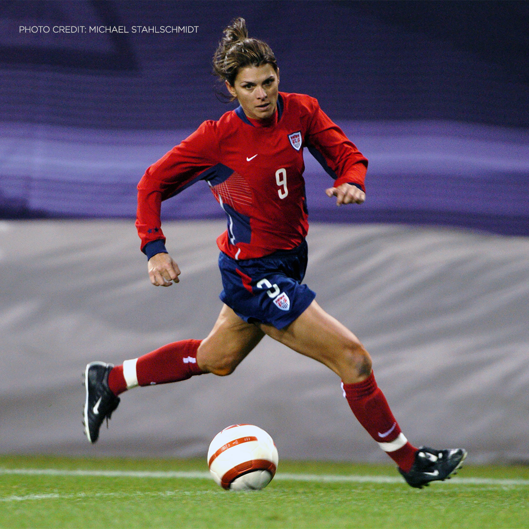 woman dribbling soccer ball