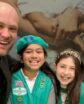 man posing with two girl scouts