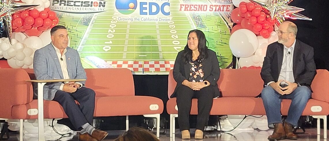 three people on a stage