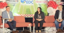 three people on a stage