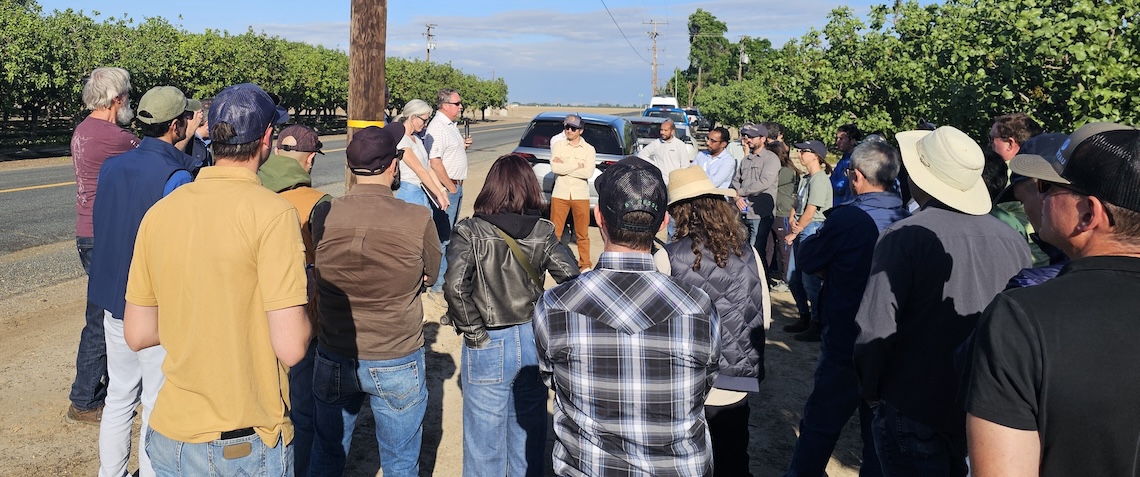 group of people outside a farm field
