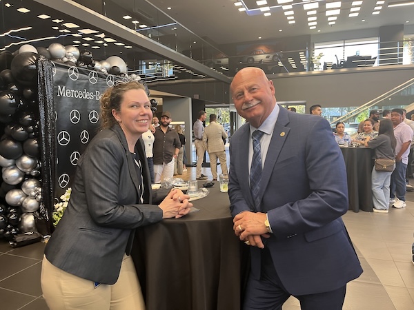 two people lean on a table