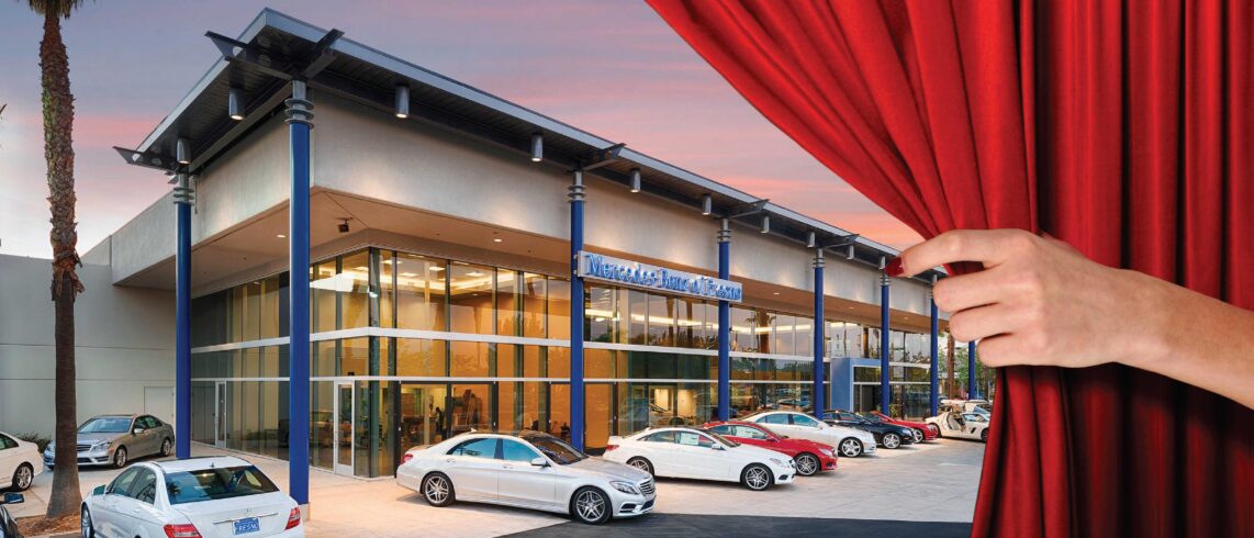 luxury auto dealership behind a red curtain with a hand extended
