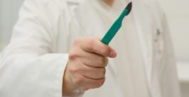 person holding scalpel