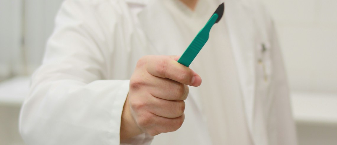 person holding scalpel