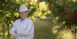 man in a cowboy hat in a vineyard