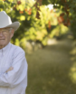 man in a cowboy hat in a vineyard