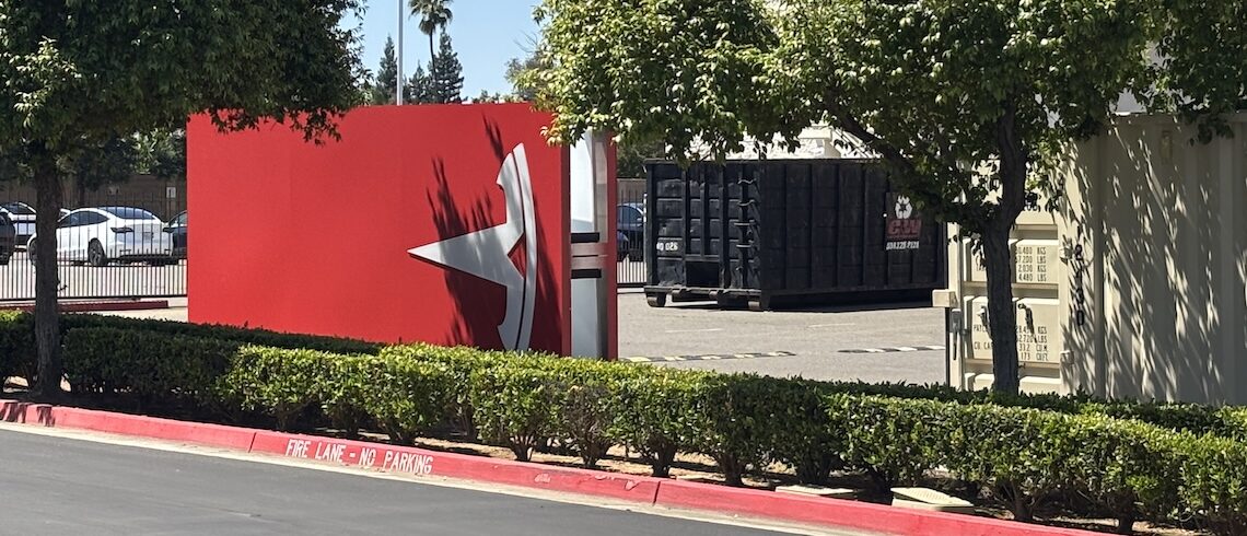 tesla t sign sitting sideways in a parking lot