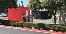 tesla t sign sitting sideways in a parking lot