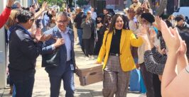 two people carrying a box between two lines of people