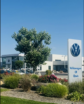 two vehicles and a dealership in middle