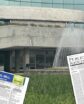a city hall with newspaper issues in front