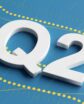 A graphic of the term "Q2" block letters on top of a blue background