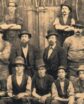 black and white image of men circa 1860s in victorian dress