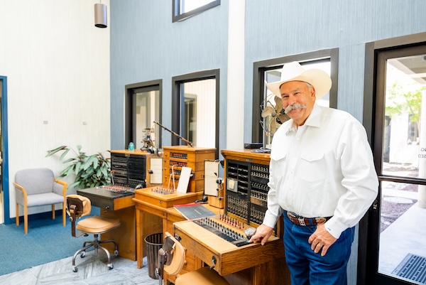 man posing with old-time switchboard