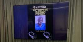 man's mugshot on a television screen