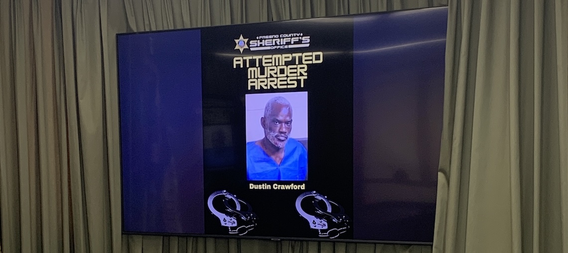 man's mugshot on a television screen