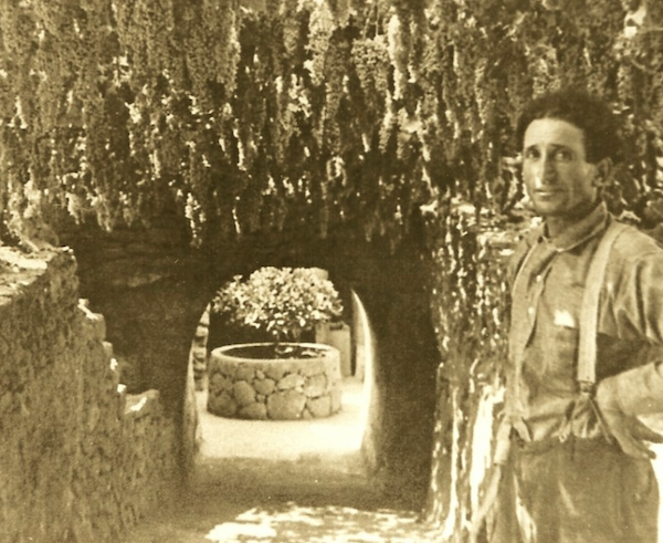 black and white photo of a man standing in front of a tunnel