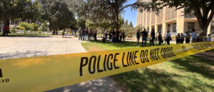 Yellow law enforcement tape cordons off a section of Courthouse Park in Downtown Fresno.