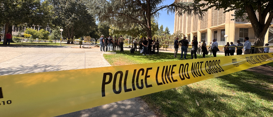 Yellow law enforcement tape cordons off a section of Courthouse Park in Downtown Fresno.