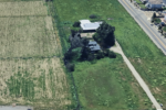 aerial view of a field with an old home