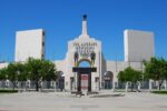 The entrance and facade of the Los Angeles Memorial Coliseum in Los Angeles, with the Olympic rings displayed above the central arch.