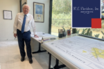 R.L. Davidson founder Robert Davidson stands beside architectural plans in the firm’s Clovis office.