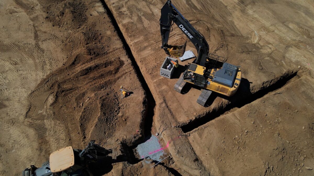 trench digging on a construction site with machinery