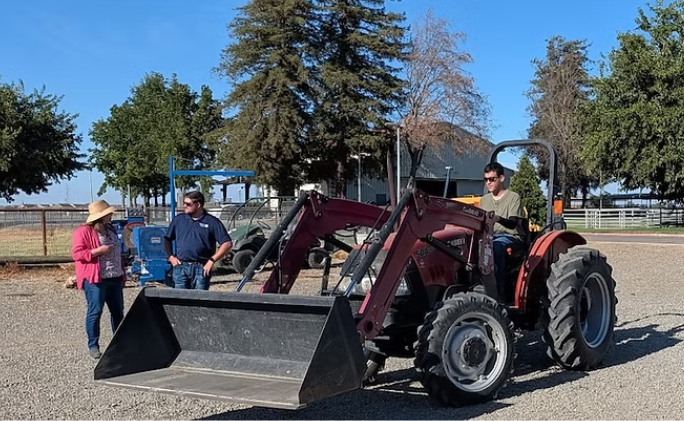 person sitting on a tractor