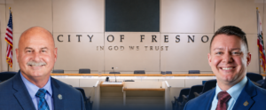 council dais and two men's headshots