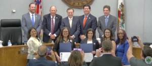 a group photo of several people, two rows