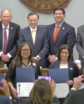 a group photo of several people, two rows