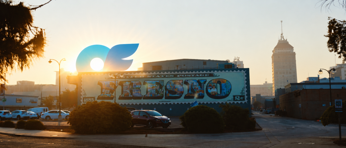 a building with a mural with sunrise and an only fans logo rising over the building