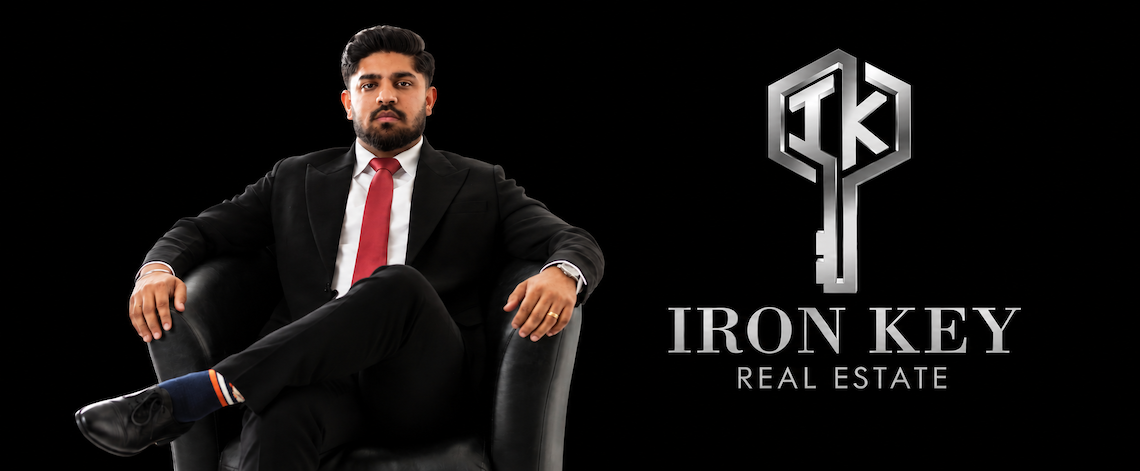 Lovepreet Chandi of Iron Key Real Estate seated beside the company’s logo.
