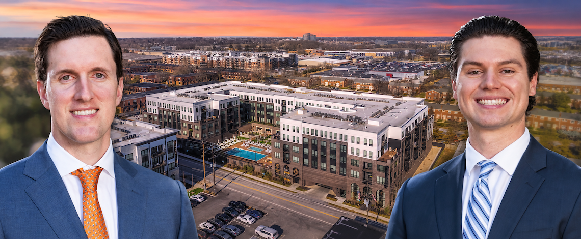 two men with a backdrop of an apartment complex