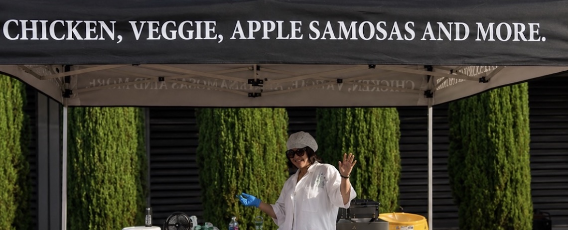 woman at a tent selling food