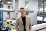 Tangram Interiors President and CEO Nick Meter stands inside a commercial office space.
