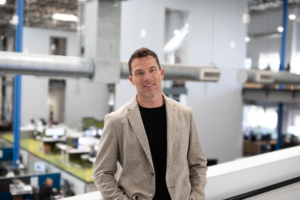 Tangram Interiors President and CEO Nick Meter stands inside a commercial office space.