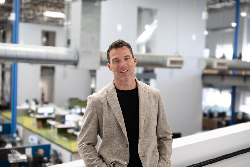 Tangram Interiors President and CEO Nick Meter stands inside a commercial office space.